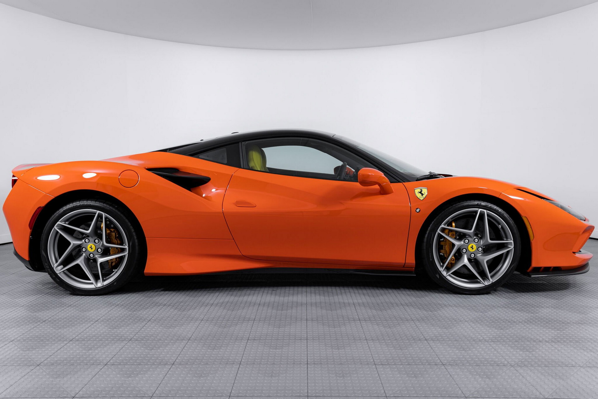 The orange Ferrari F8 Tributo with blue and yellow interior proves that money does not always buy the taste.